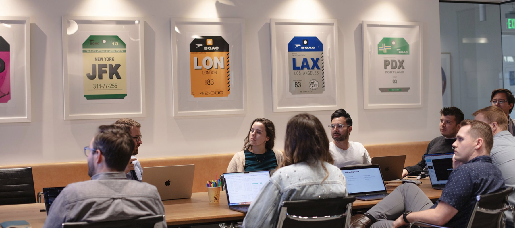 Boncom co-workers sitting around a conference table.