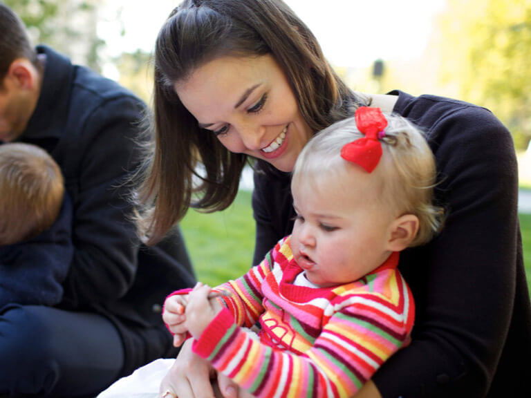 A mother holding her baby daughter.