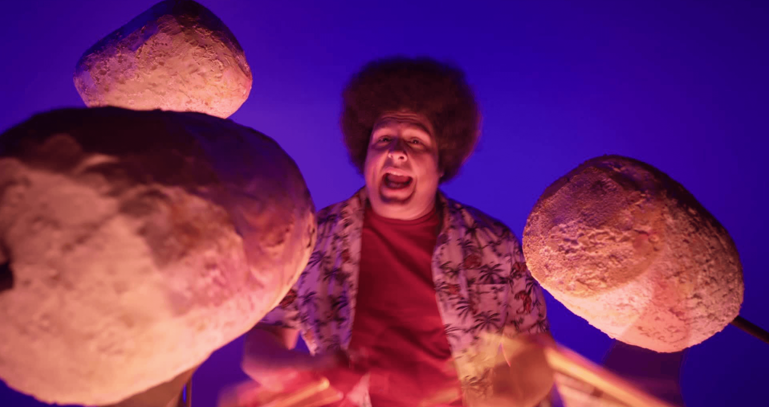 An image of "DJ Xtinguish" surrounded by oversized campfire marshmallows.